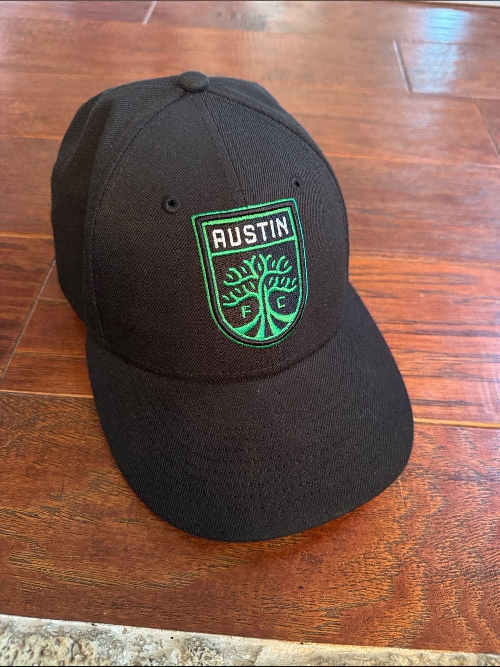 New Era Black Cap with Green Embroidered Crest